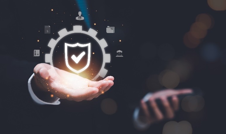 Businessperson holding shield icon for data security concept.